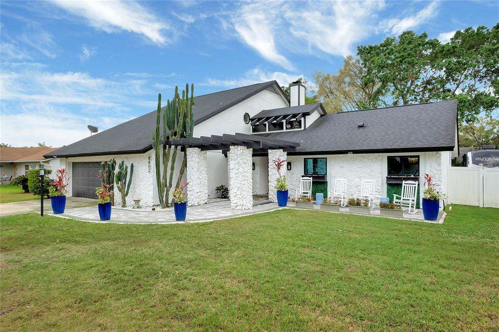 8802 Reparto Orlando, FL 32825 - Photo 1 of 1 a view of a swimming pool with a table and chairs under an umbrella