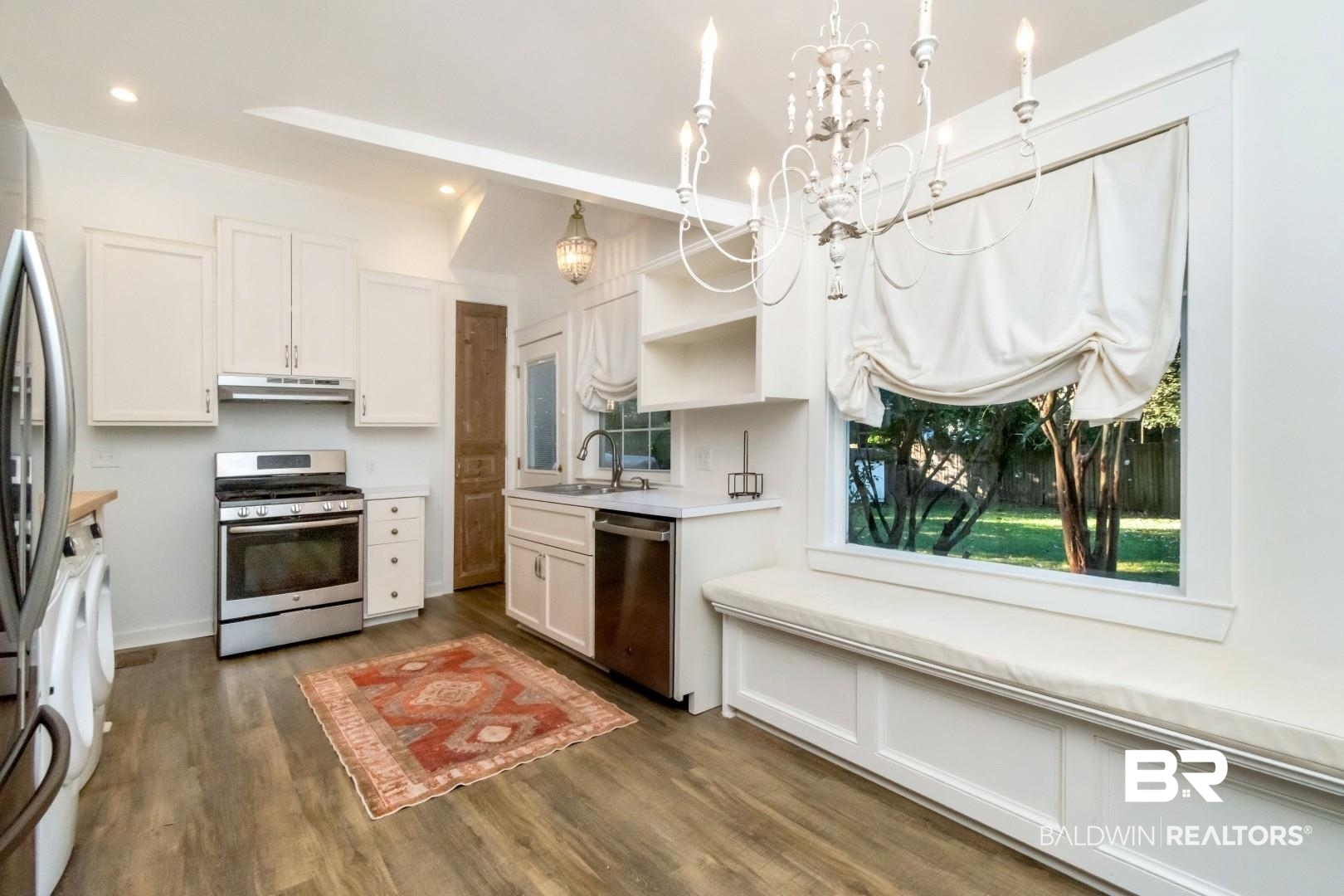 16 Princess Anne Road Mobile, AL 36608 - Photo 11 of 40 Kitchen featuring stainless steel appliances, white cabinets, light countertops, open shelves, and dark wood-style floors