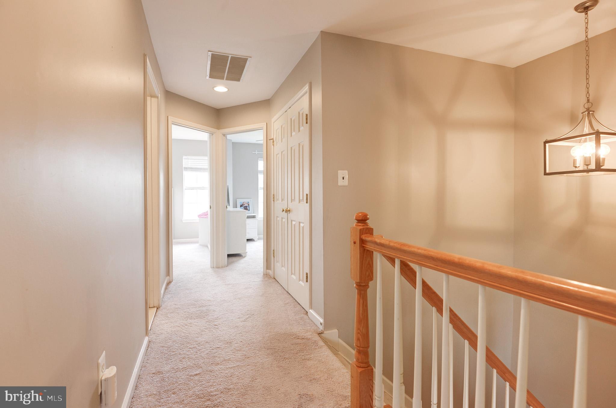 44167 Tippecanoe Terrace Ashburn, VA 20147 - Photo 21 of 56 a view of a hallway with wooden floor and a bathroom