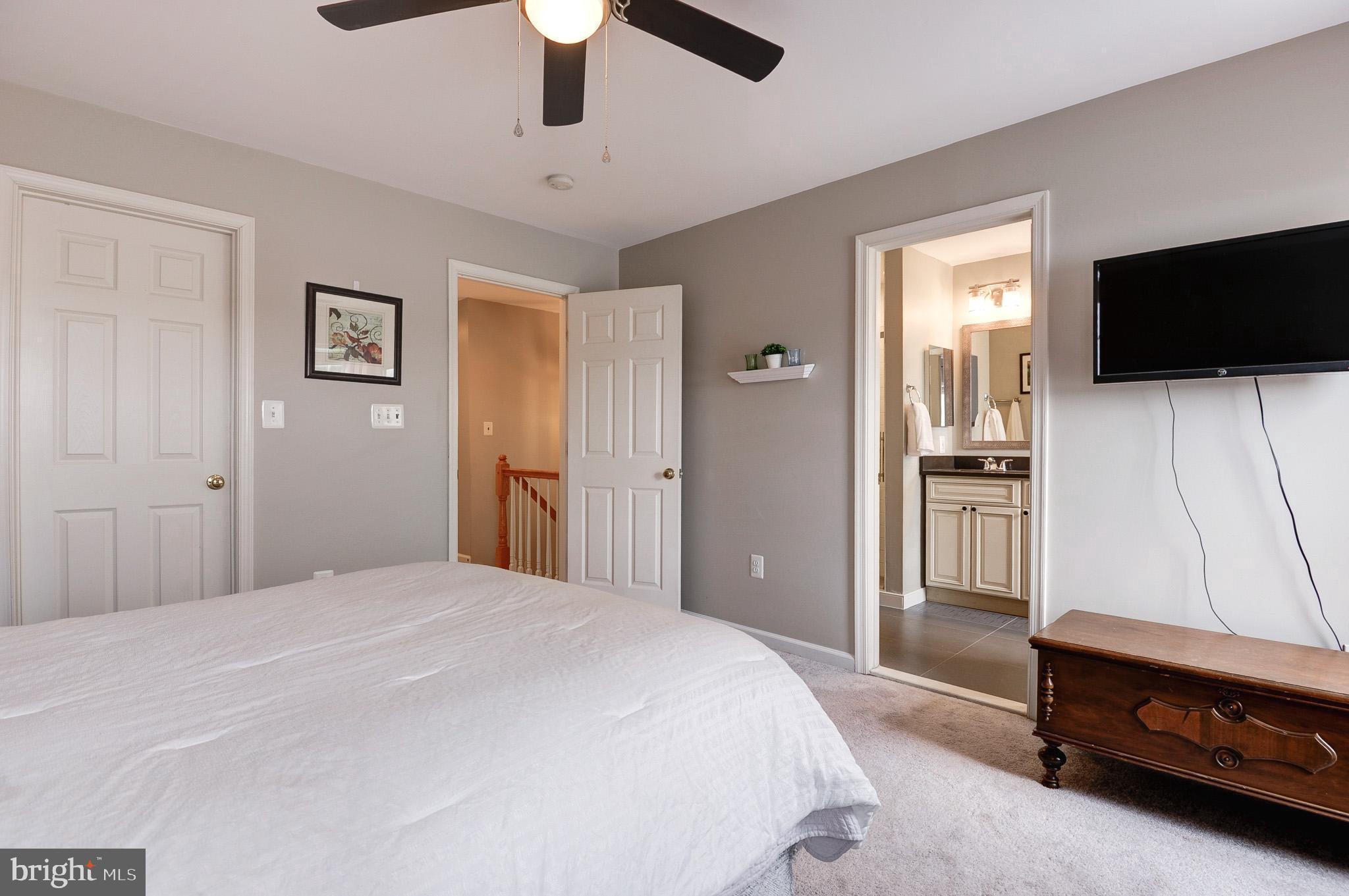 44167 Tippecanoe Terrace Ashburn, VA 20147 - Photo 24 of 56 a bedroom with a bed and a flat screen tv