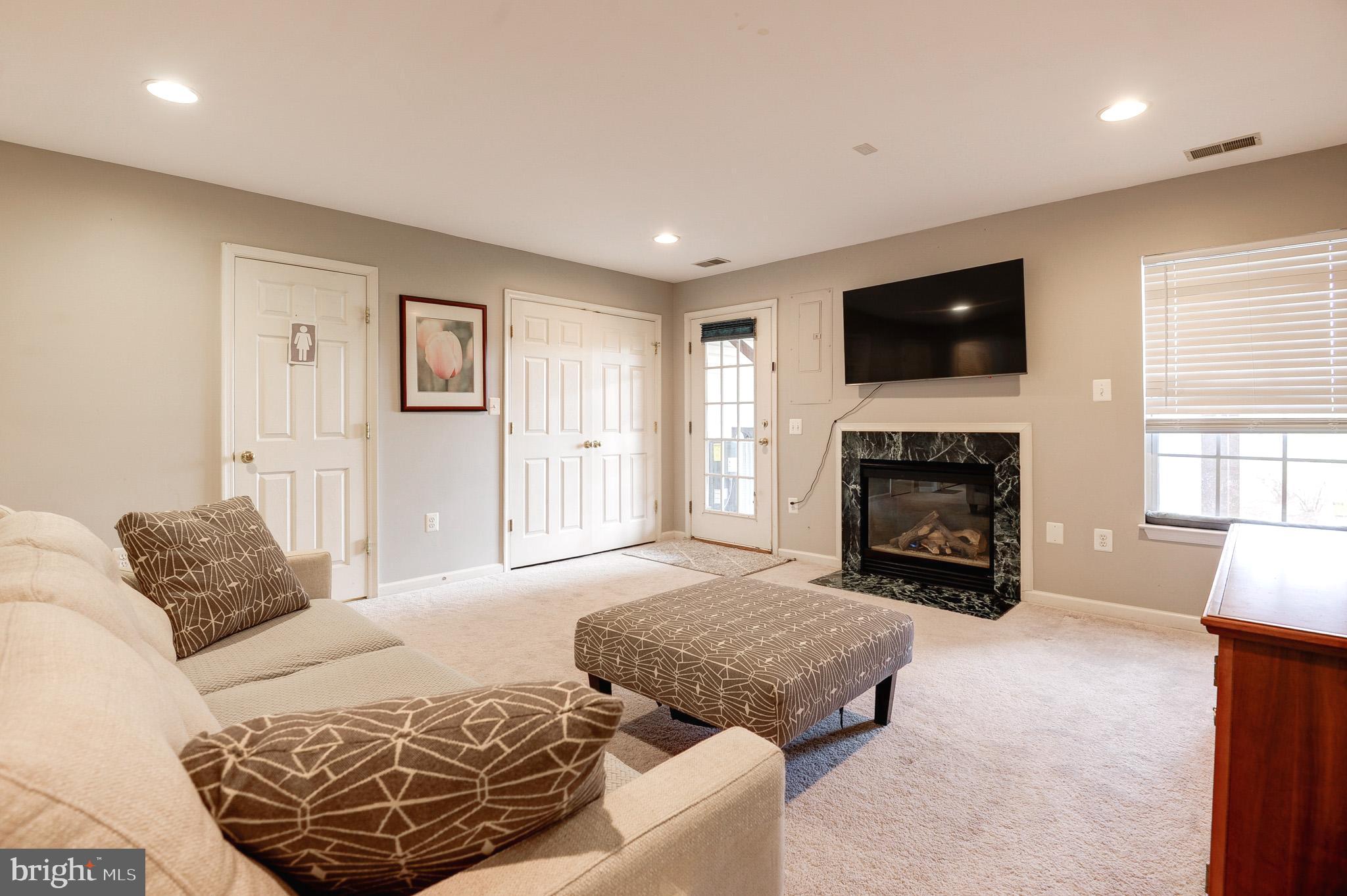 44167 Tippecanoe Terrace Ashburn, VA 20147 - Photo 35 of 56 a spacious bedroom with a bed and a fireplace