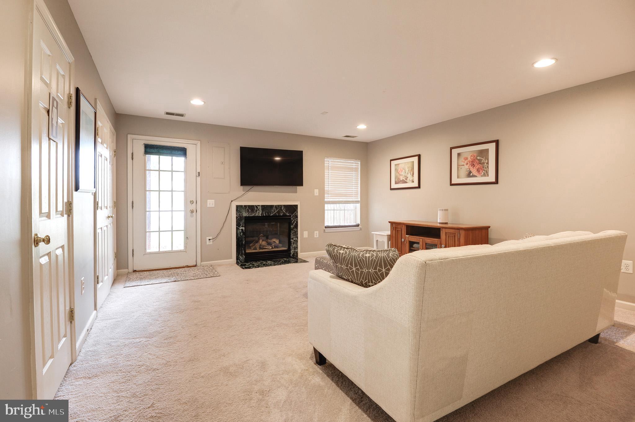 44167 Tippecanoe Terrace Ashburn, VA 20147 - Photo 38 of 56 a living room with furniture and a fireplace