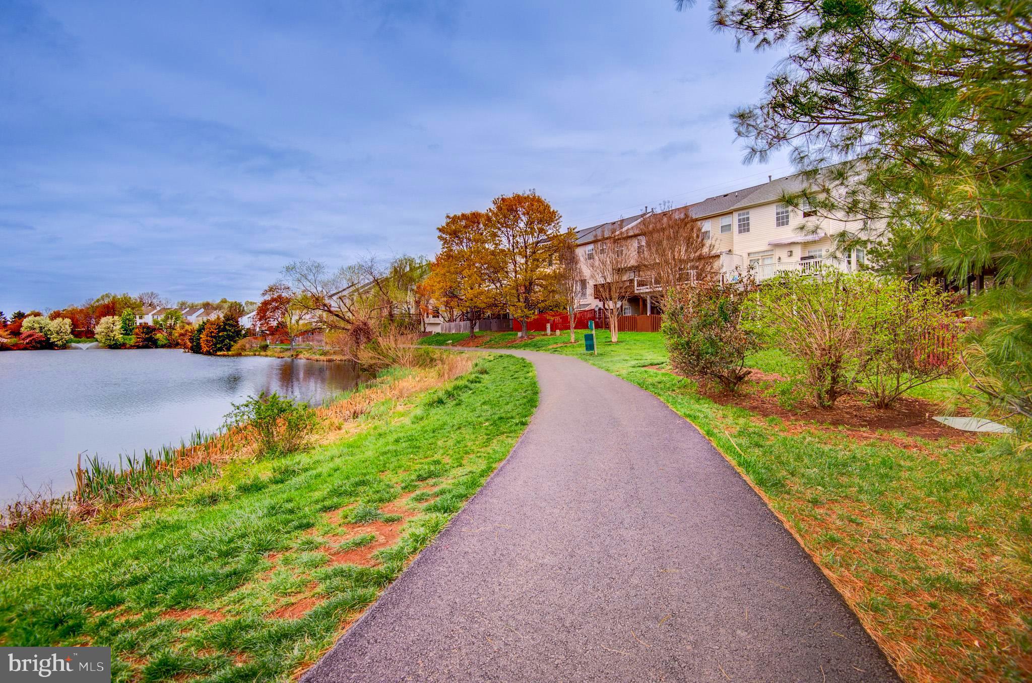 44167 Tippecanoe Terrace Ashburn, VA 20147 - Photo 50 of 56 a view of a lake with a building in the background