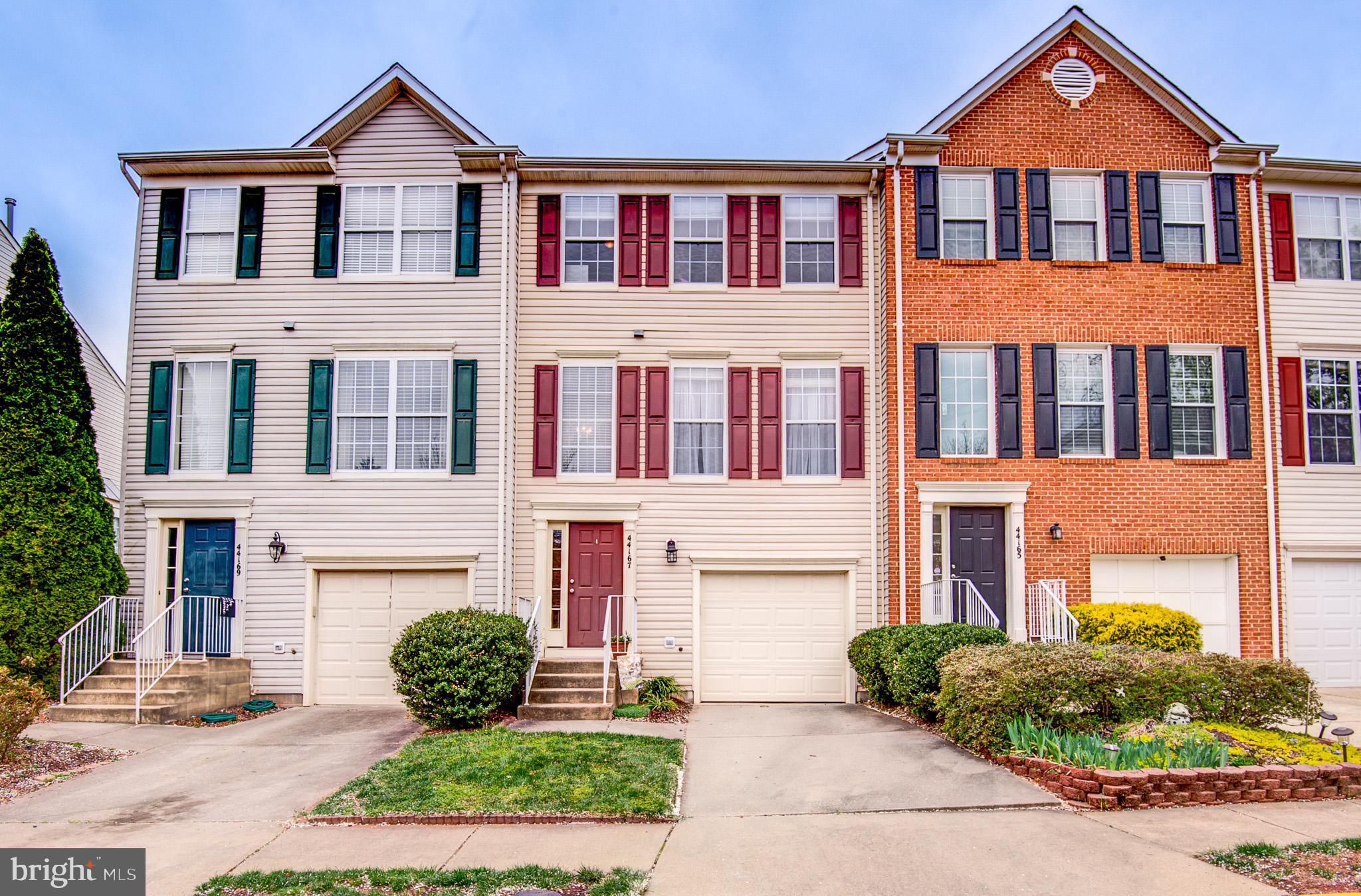44167 Tippecanoe Terrace Ashburn, VA 20147 - Photo 56 of 56 a front view of a house with a yard and potted plants