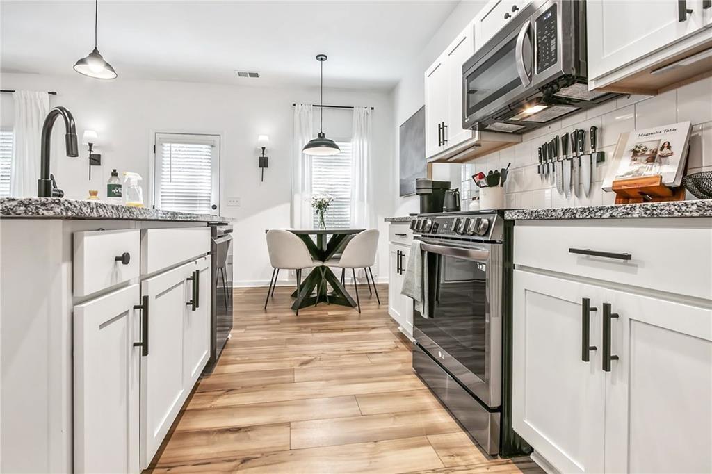 1363 Cooper Springs Road Grayson, GA 30017 - Photo 8 of 28 a kitchen with stainless steel appliances granite countertop a stove and a sink