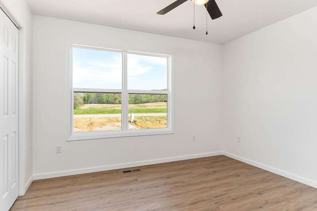 523 Dr I C Morgan Road Spencer, TN 38585 - Photo 11 of 25 an empty room with a window and wooden floor