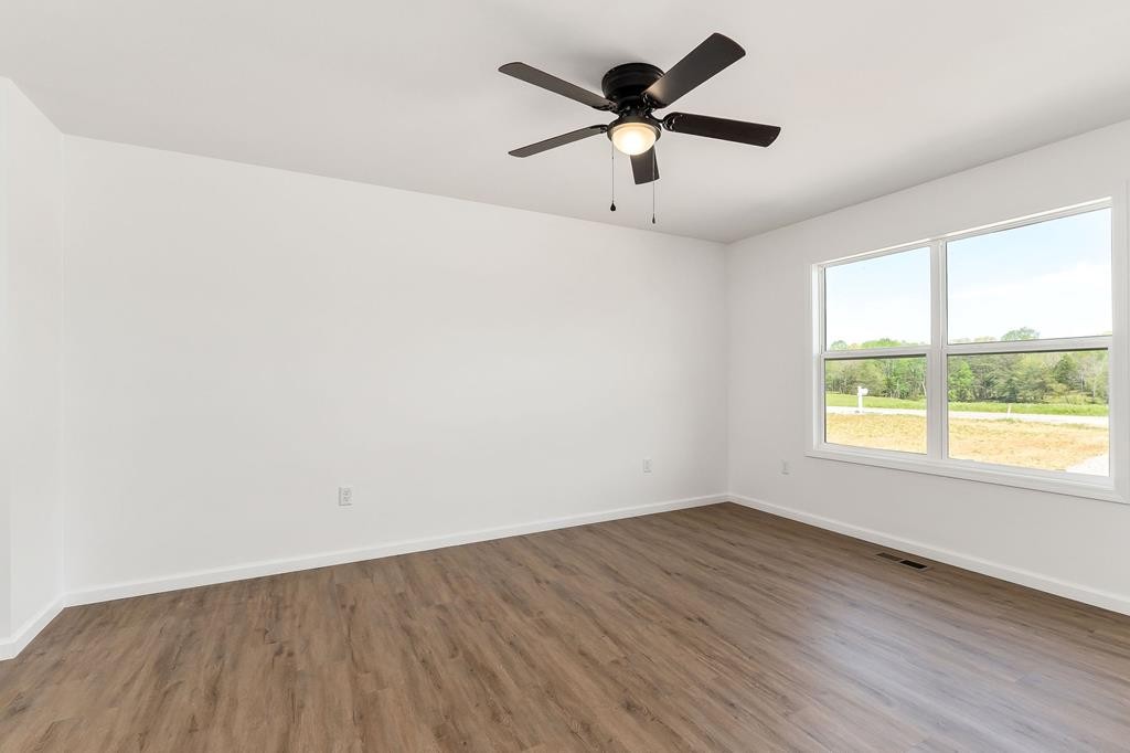 523 Dr I C Morgan Road Spencer, TN 38585 - Photo 16 of 25 an empty room with wooden floor and windows