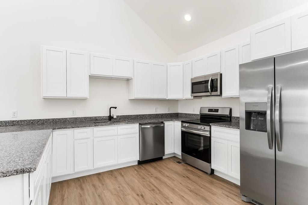 523 Dr I C Morgan Road Spencer, TN 38585 - Photo 22 of 25 a kitchen with a sink stainless steel appliances and white cabinets