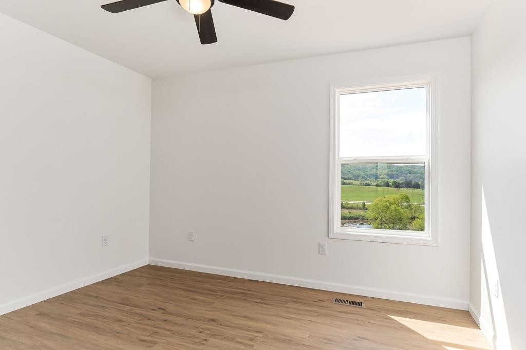 523 Dr I C Morgan Road Spencer, TN 38585 - Photo 23 of 25 an empty room with wooden floor fan and windows