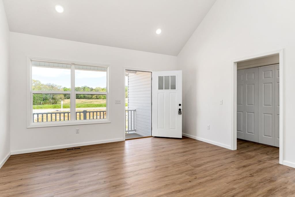 523 Dr I C Morgan Road Spencer, TN 38585 - Photo 6 of 25 an empty room with wooden floor and windows