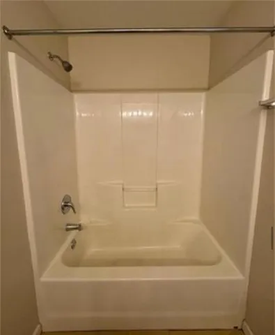 a bathroom with a shower and a bath tub