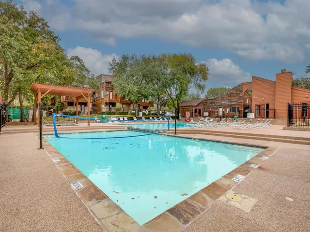 a view of swimming pool with outdoor seating and city view