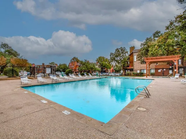 an aerial view of residential houses with outdoor space and lake view