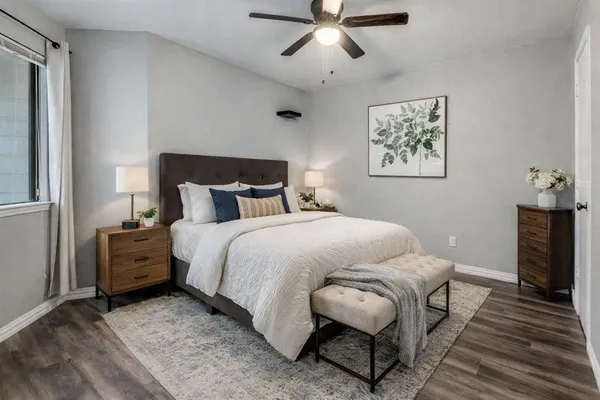 a bedroom with a bed and a chandelier