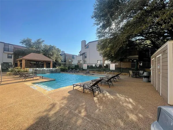a view of swimming pool with outdoor seating and yard