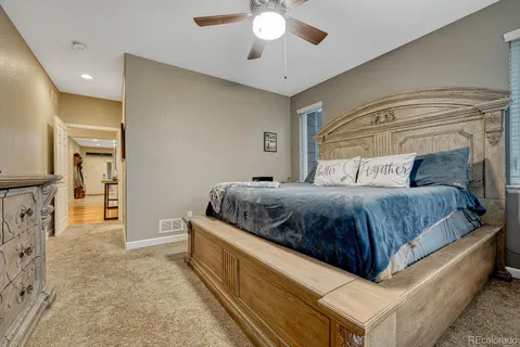 a bedroom with a large bed and a chandelier
