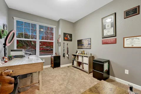 a bedroom with furniture and a flat screen tv