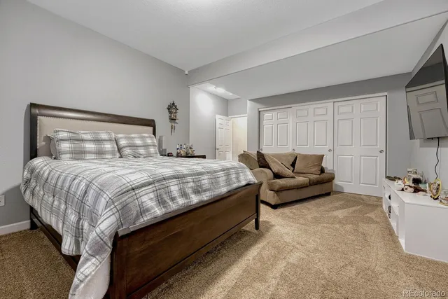 a bedroom with a bed and couch