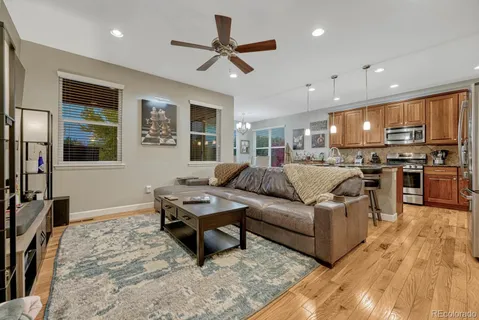 a living room with furniture kitchen and a table