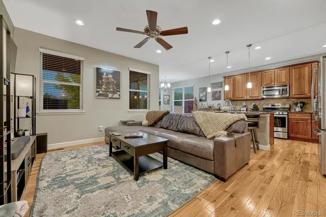 a living room with furniture kitchen and a table
