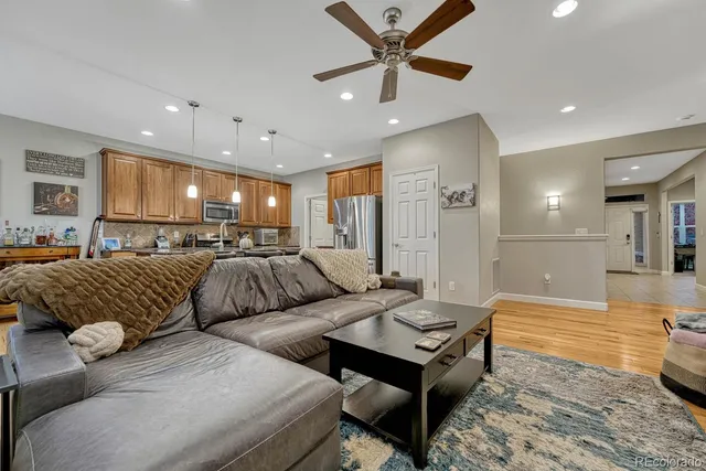 a living room with furniture and a chandelier