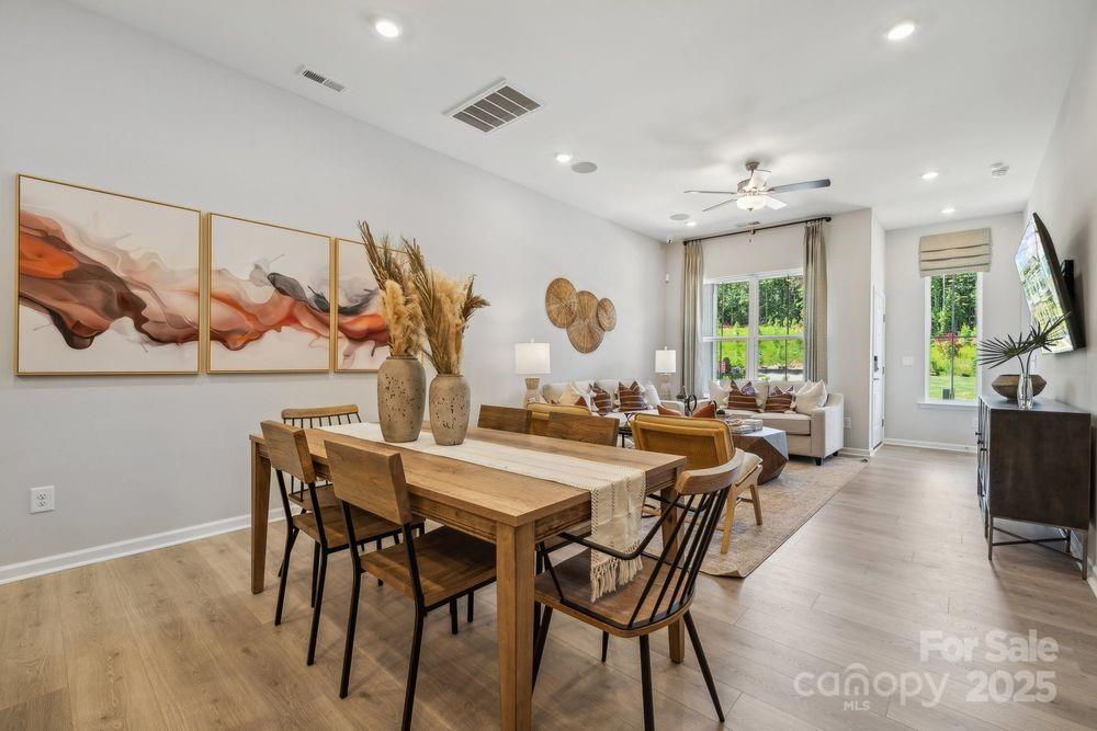 3151 Beacon Hts Road Indian Land, SC 29707 - Photo 7 of 34 a view of a dining room and livingroom view with furniture wooden floor and a large window