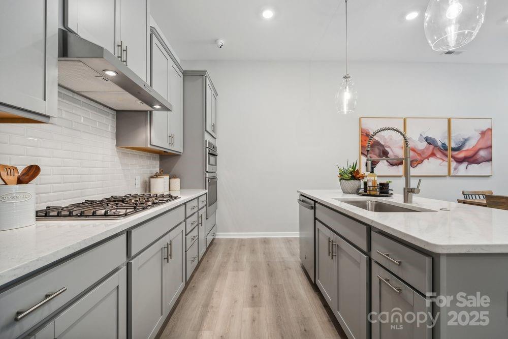 3151 Beacon Hts Road Indian Land, SC 29707 - Photo 8 of 34 a kitchen with stainless steel appliances a sink stove and cabinets
