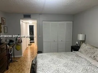 a bedroom with a bed and a closet