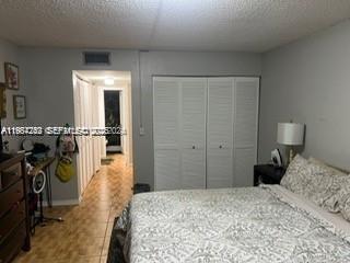 3253 Foxcroft Road, Unit G107 Miramar, FL 33025 - Photo 5 of 10 a bedroom with a bed and a closet