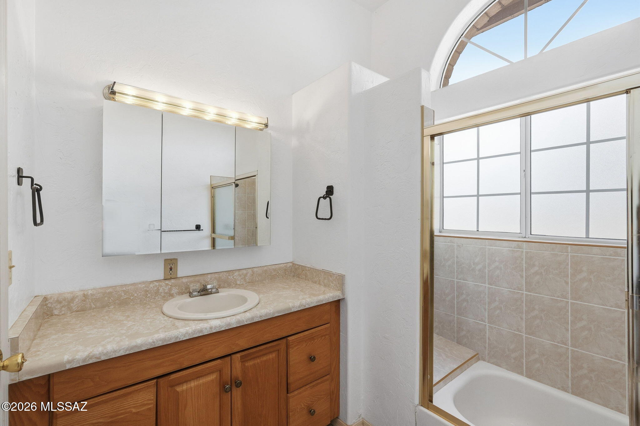 1242 Vista Court Rio Rico, AZ 85648 - Photo 28 of 51 The first of two guest bathrooms is designed with both comfort and everyday convenience in mind. Cultured marble countertops provide plenty of space for everyone’s personal hygiene products and daily essentials, while a Kohler toilet adds a quality finishing touch. The convenient tub/shower combination is especially nice for children, giving them the option of a quick shower or the chance to draw a warm bath and sit back and soak. With generous countertop space and a practical layout, busy mornings and evening routines can be handled with ease.