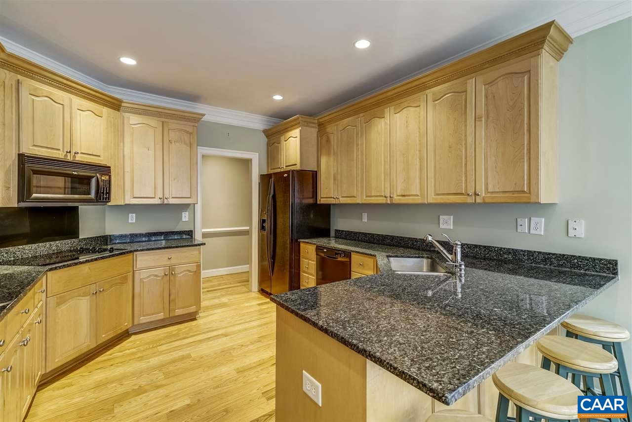 3398 Darby Road Keswick, VA 22947 - Photo 17 of 50 a kitchen with stainless steel appliances granite countertop a sink a microwave cabinets and a counter top space