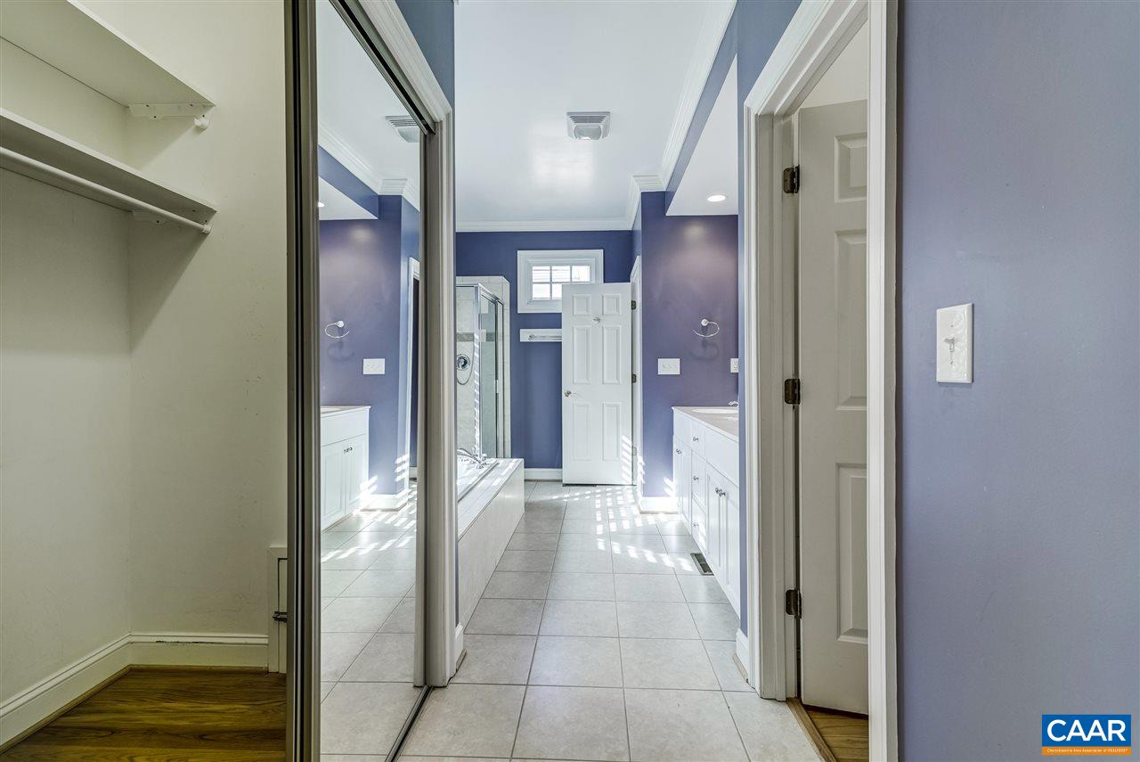 3398 Darby Road Keswick, VA 22947 - Photo 26 of 50 a view of a hallway with wooden floor and a bathroom