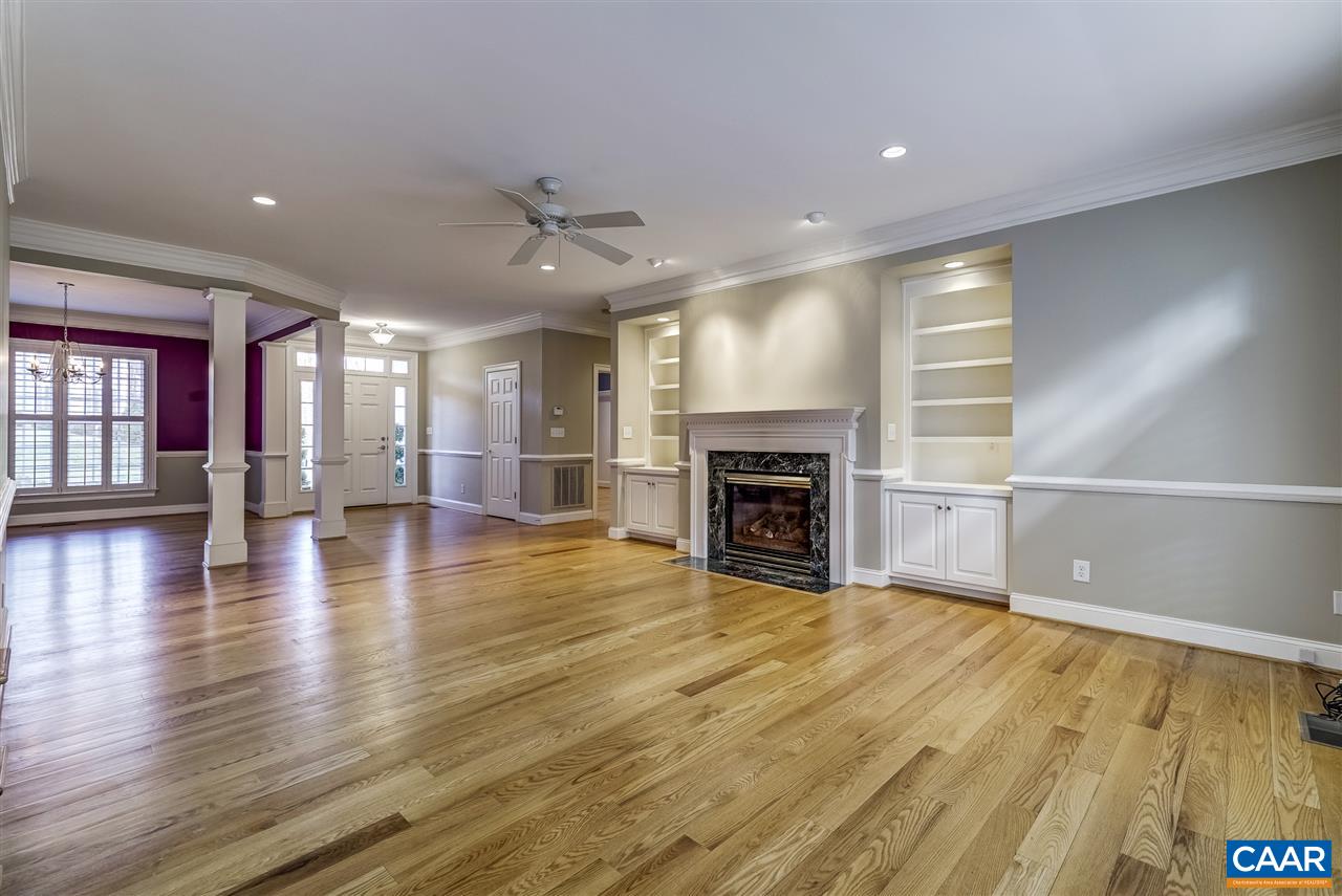 3398 Darby Road Keswick, VA 22947 - Photo 10 of 50 an empty room with wooden floor fireplace and windows