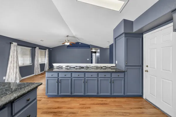 a bathroom with a granite countertop double vanity sink and a large mirror