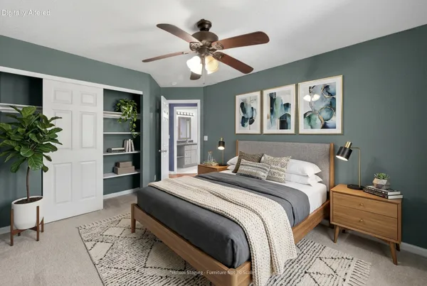 a bedroom with a bed and a potted plant