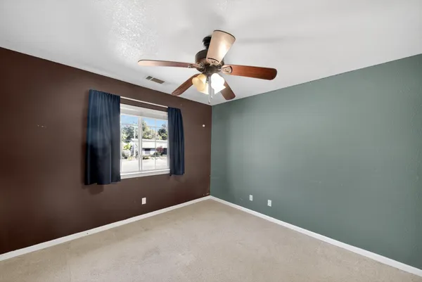 a workspace with a chandelier fan and a window