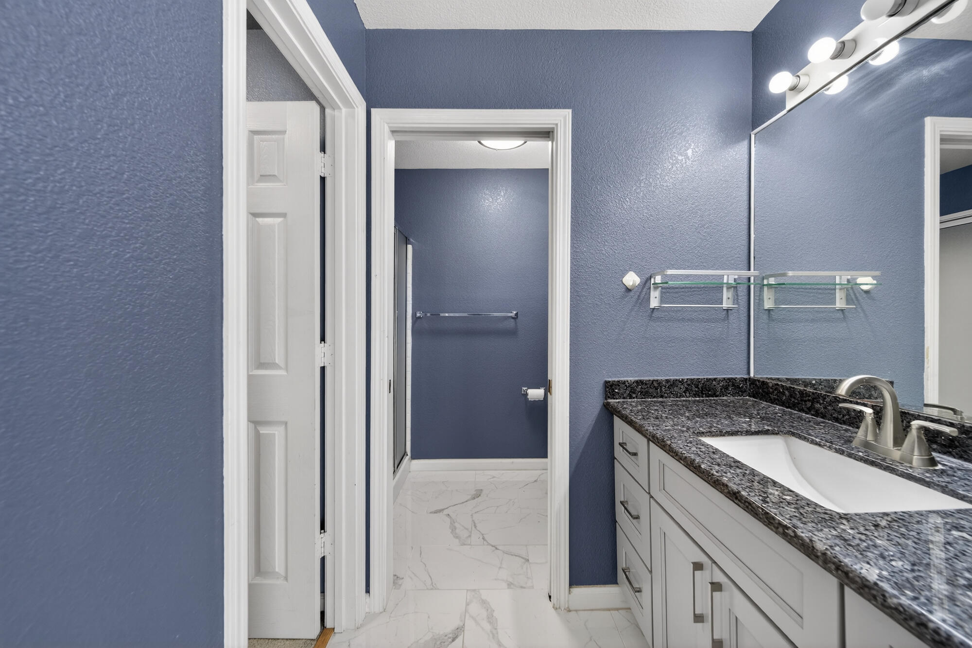 3360 Lawrence Road Redding, CA 96002 - Photo 26 of 43 a bathroom with a granite countertop sink and a mirror
