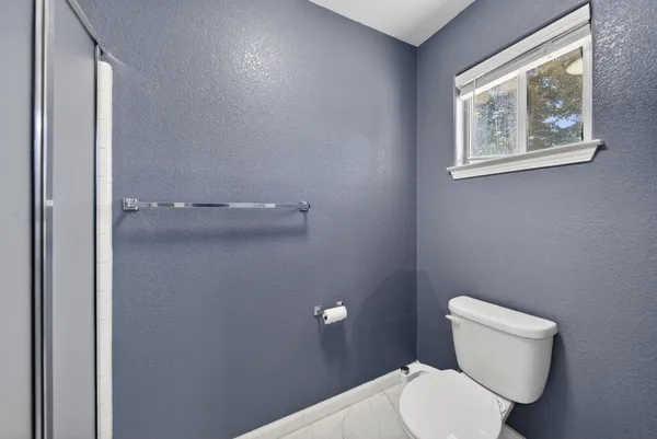 a white toilet sitting next to a bathroom sink