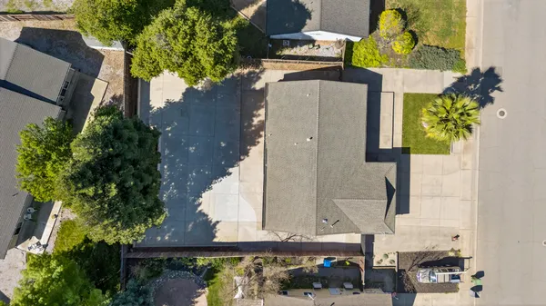 an aerial view of a house with a yard