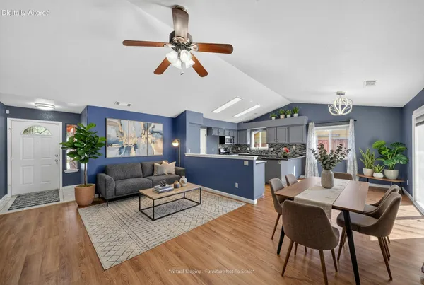 a living room with furniture and a wooden floor
