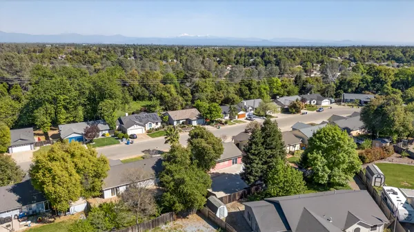 an aerial view of a house with swimming pool and outdoor space