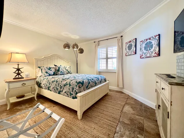 a bedroom with a large bed and a window