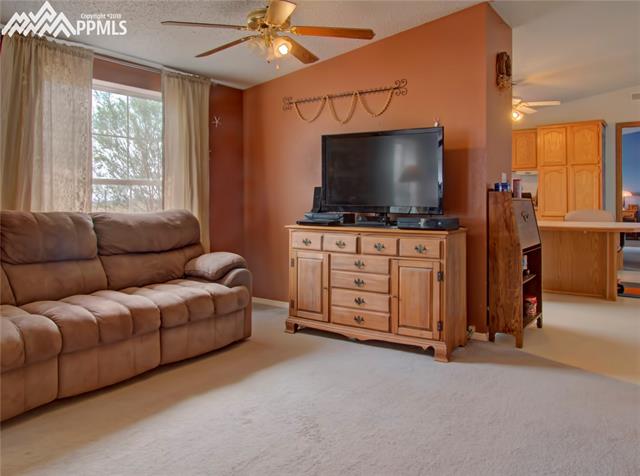 890 Ranchette Place Calhan, CO 80808 - Photo 7 of 26 The family room looking into the kitchen with the master suite on the other side of the kitchen