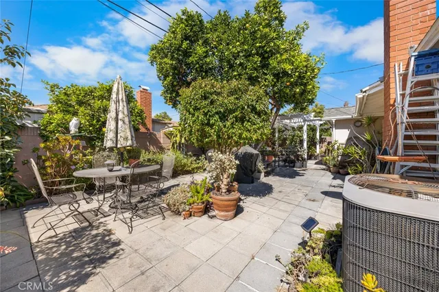 a view of a patio with table and chairs and potted plants