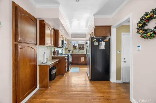 a kitchen with stainless steel appliances granite countertop a refrigerator and a sink