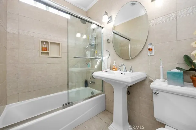 a bathroom with a sink a mirror a bathtub and vanity