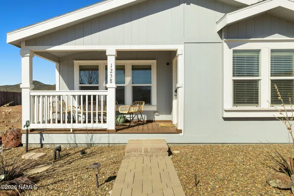 a view of a house with wooden deck