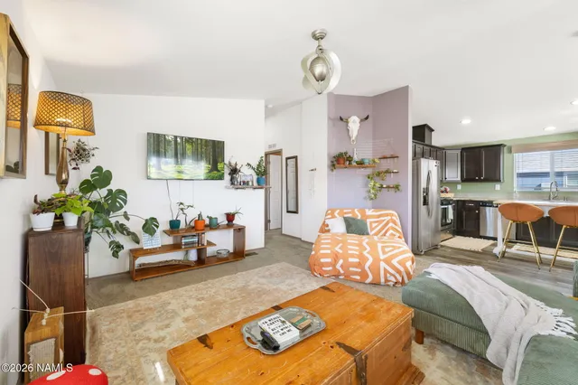 a living room with furniture and flat screen tv