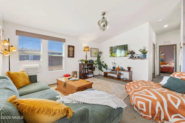 a bedroom with furniture and a large window