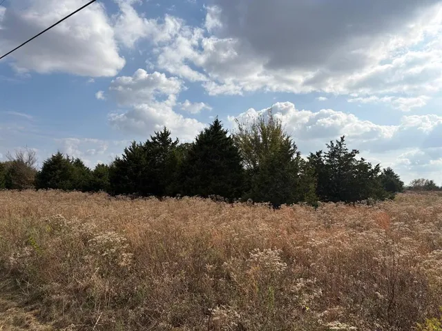a view of a lake with a car parked on the roadside